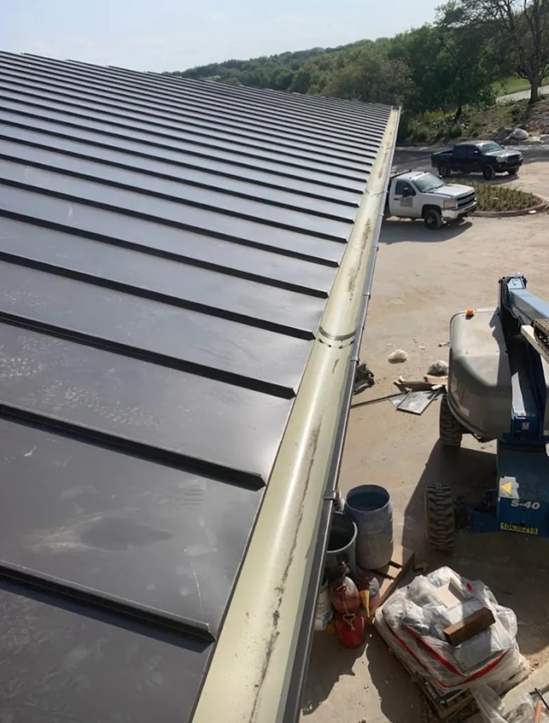 Standing seam panel and gutter detail on a metal roofing jobsite in Mission